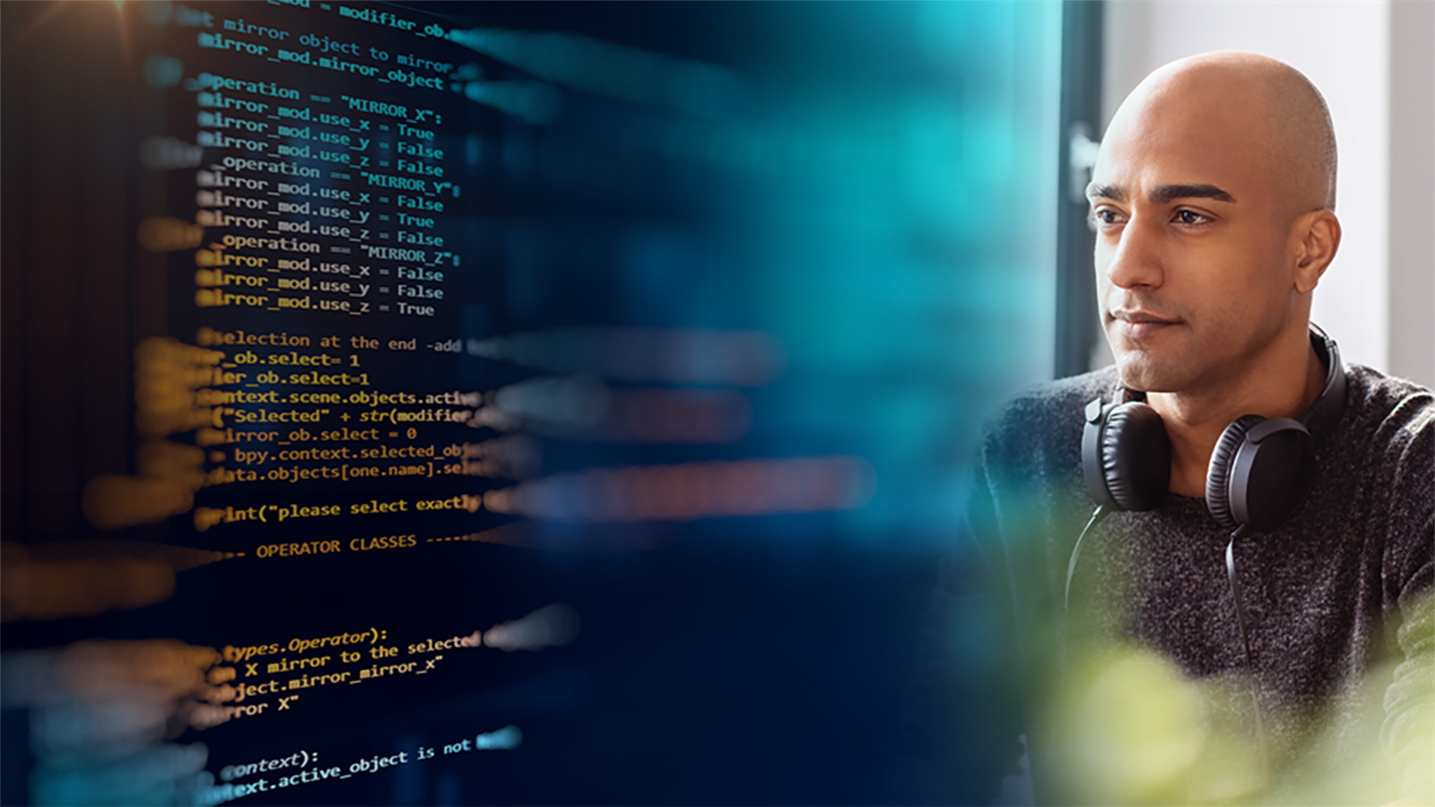 Image of man coding and screen